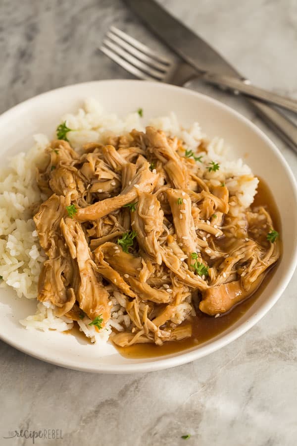 instant pot honey garlic chicken with rice on white plate with fork in the background
