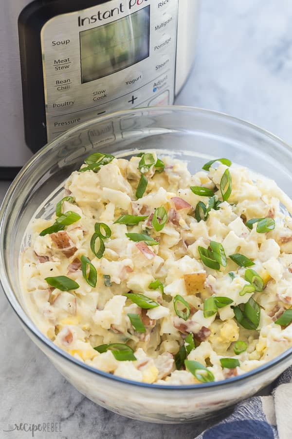 instant pot potato salad with pressure cooker and green onions on top