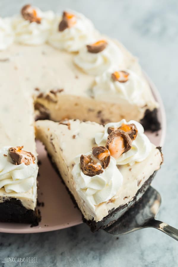 slice of no bake cadbury creme egg cheesecake being pulled out of whole