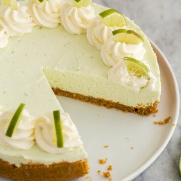 square image of no bake key lime cheesecake with piece missing.