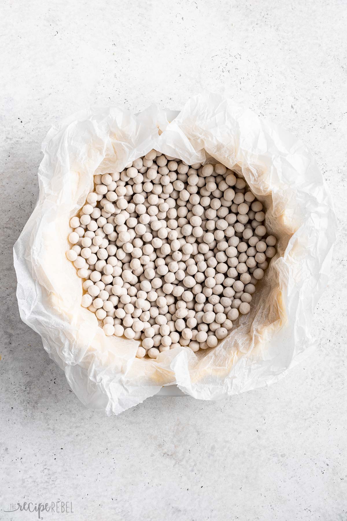 parchment and pie weights in unbaked pie crust.