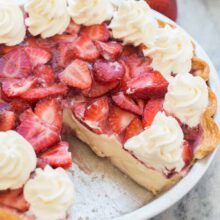 whole strawberry cream cheese pie with piece missing