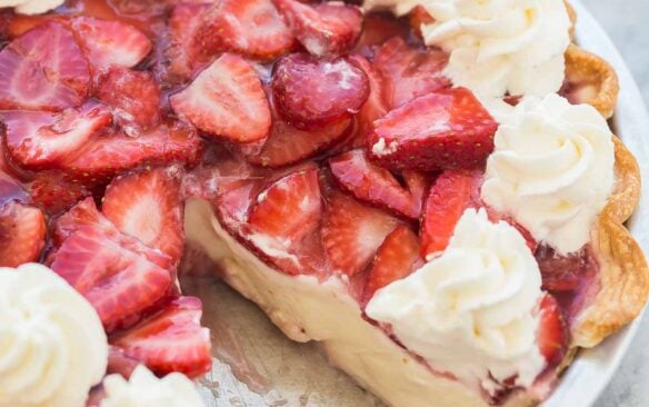 whole strawberry cream cheese pie with piece missing