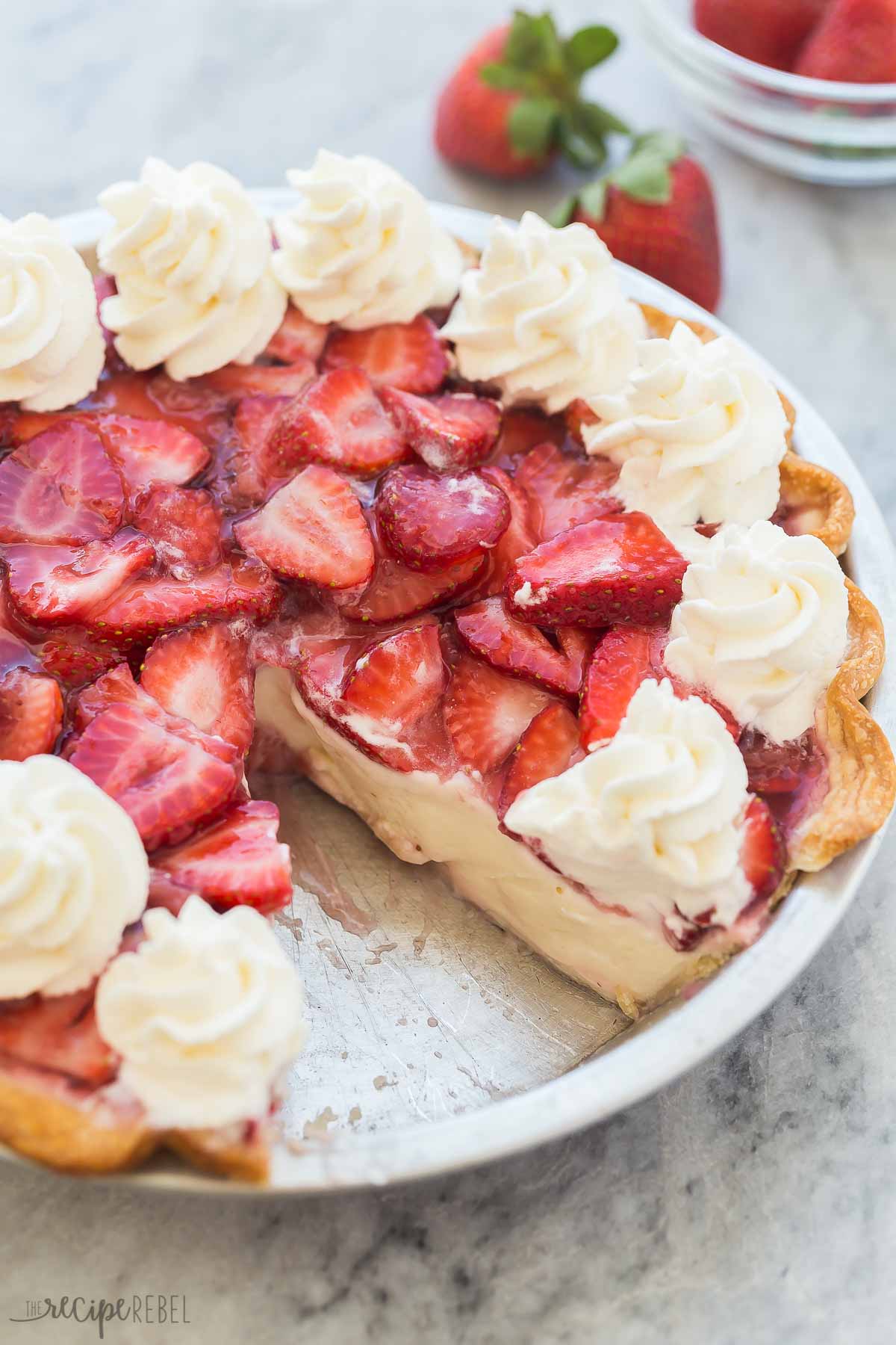 whole strawberry cream cheese pie with piece missing