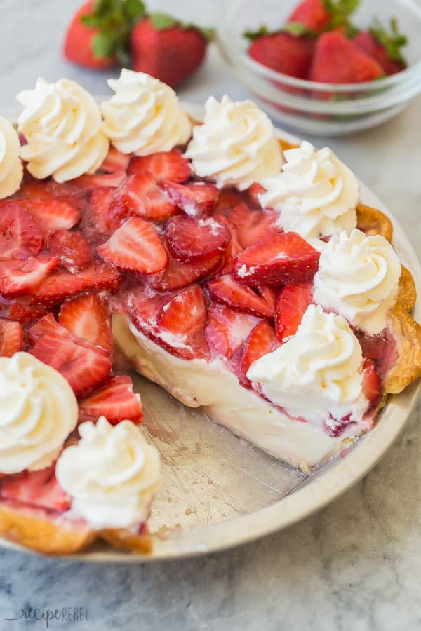 strawberry cream cheese pie in pan with one slice missing