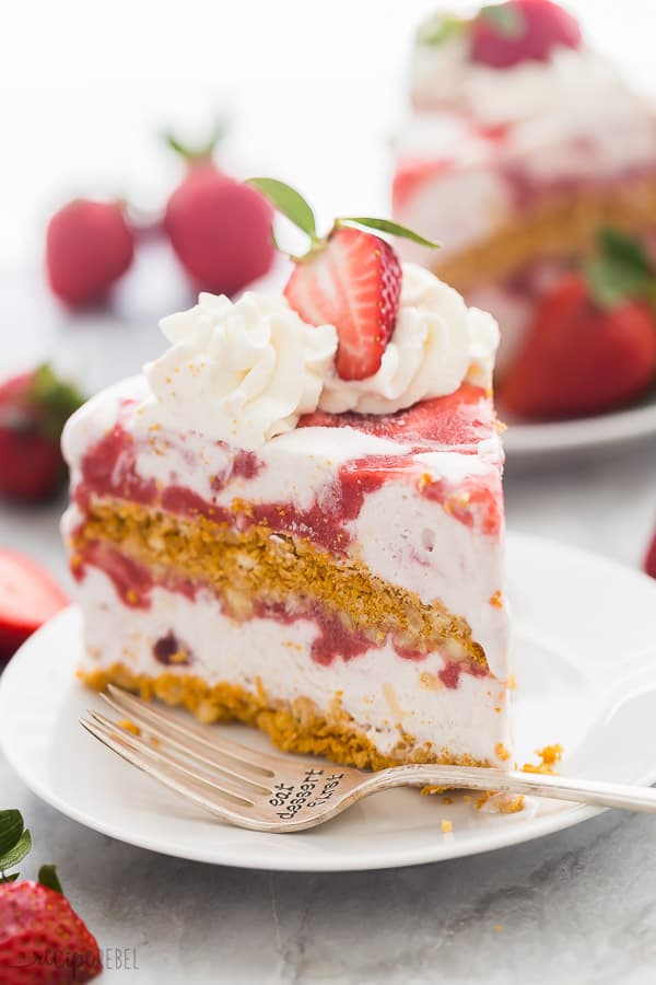 strawberry shortcake ice cream cake slice on white plate with fork on plate