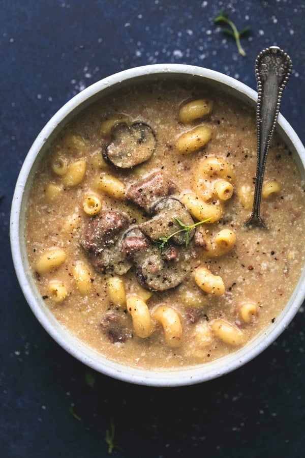 bowl of beef stroganoff soup in white bowl on dark background