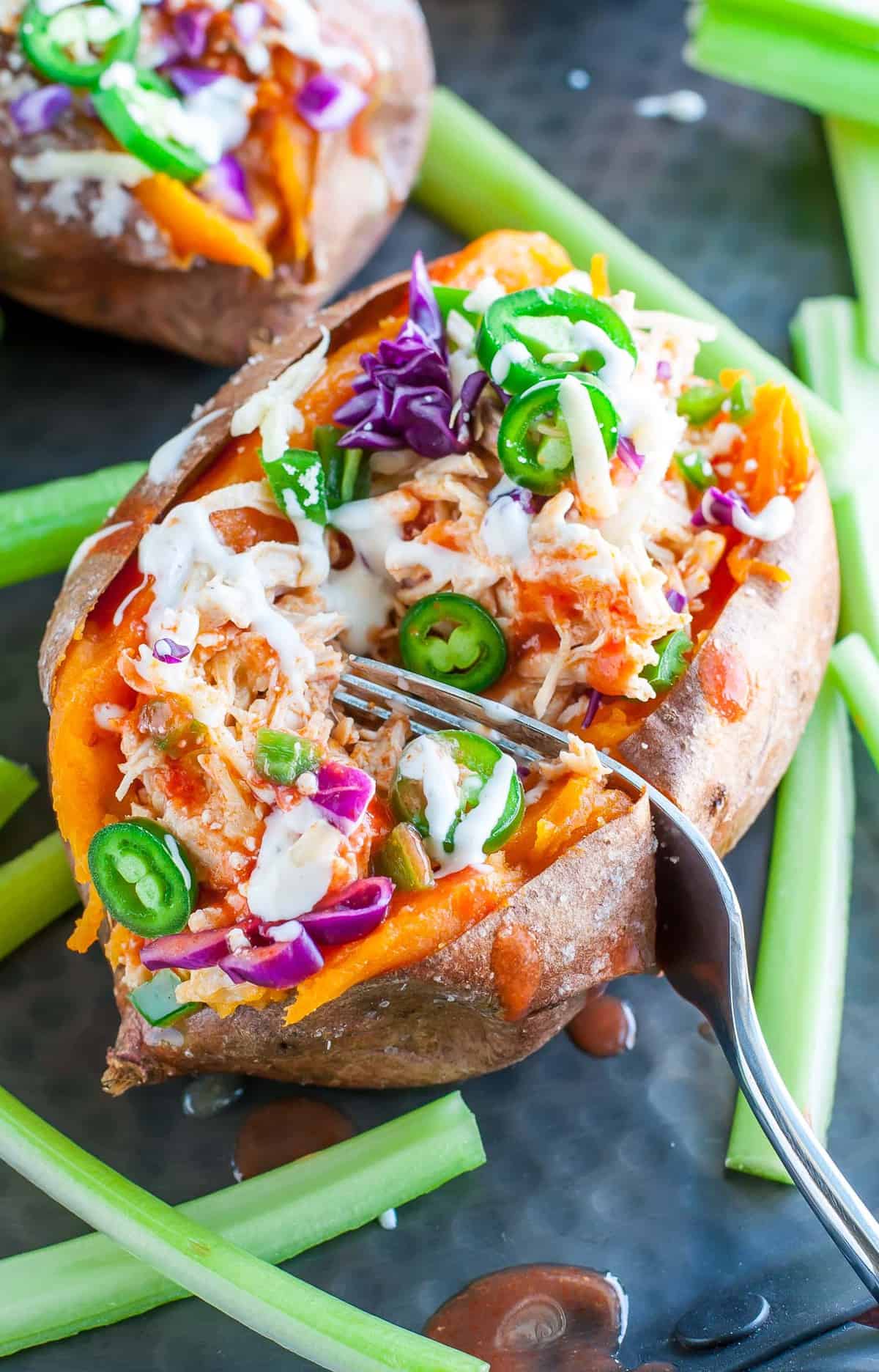 buffalo chicken sweet potatoes close up with fork cutting into one