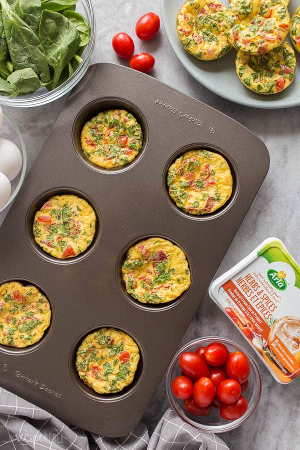 frittata muffins in muffin tin on marble background with cherry tomatoes and Arla cream cheese