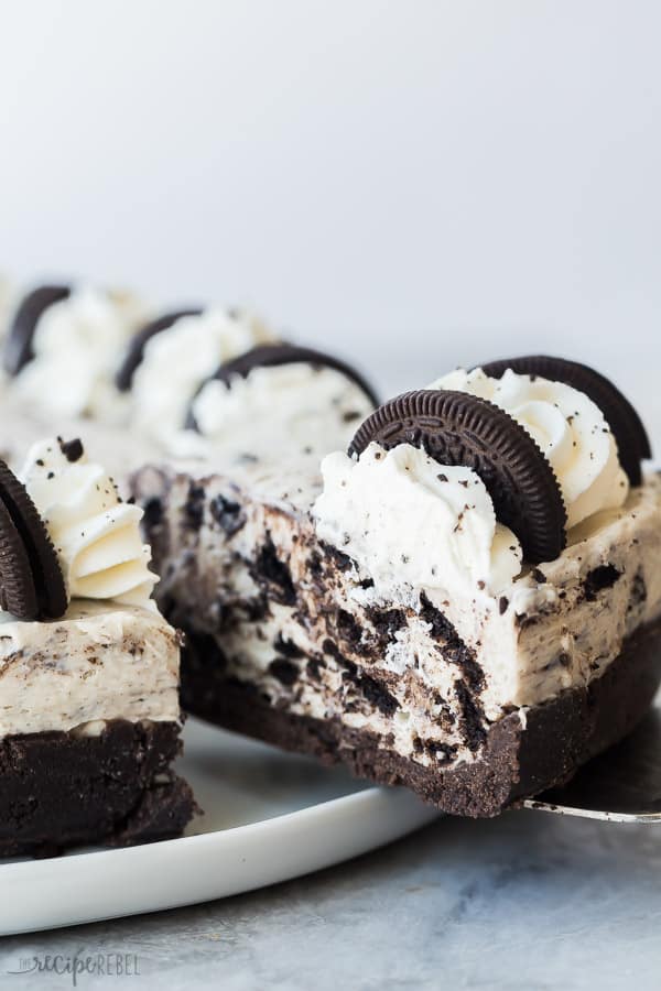 no bake oreo cheesecake slice being pulled out of whole cheesecake