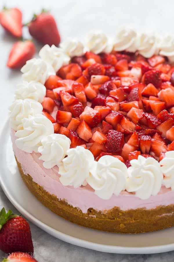 no bake strawberry cheesecake whole with chopped berries over the top