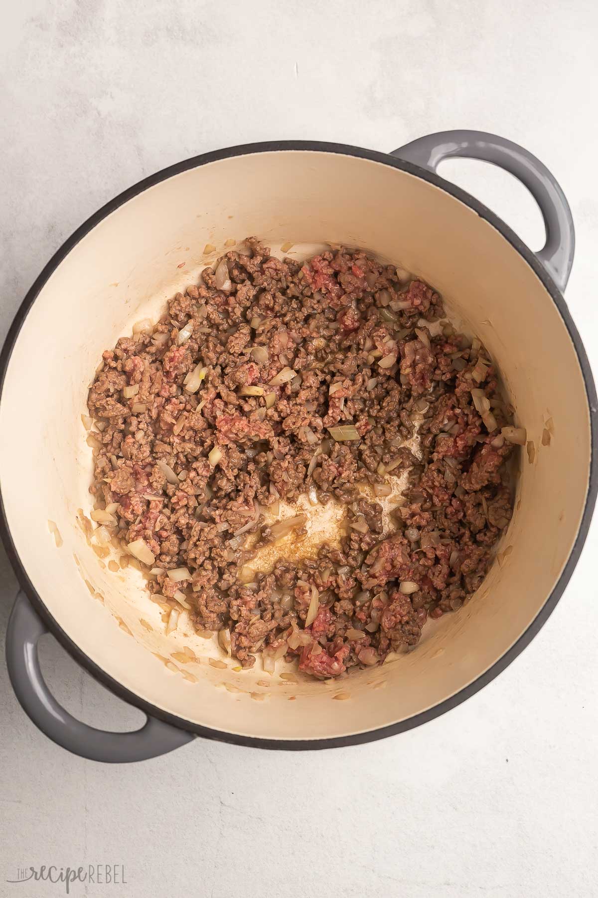 ground beef cooking in large dutch oven.