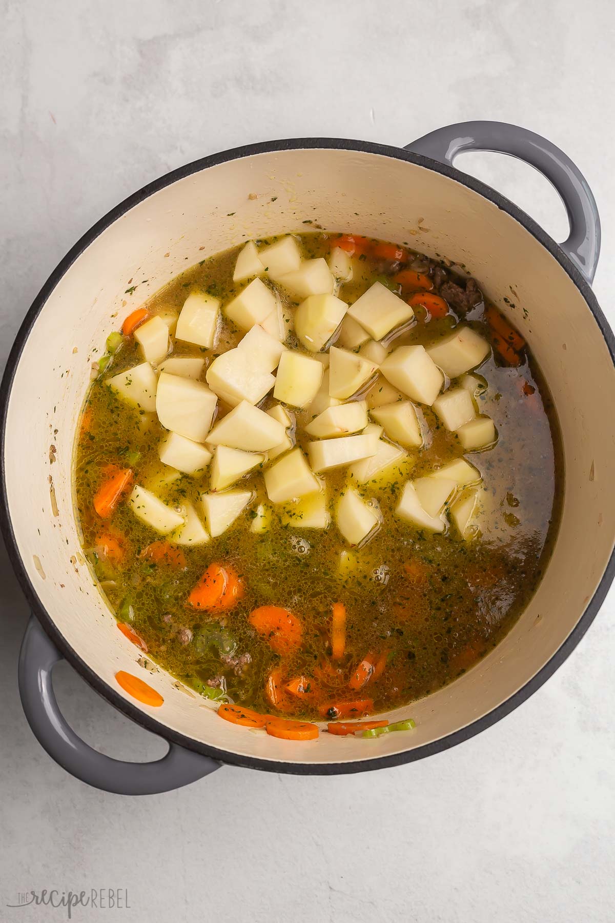 potatoes and broth added to meat and vegetables.
