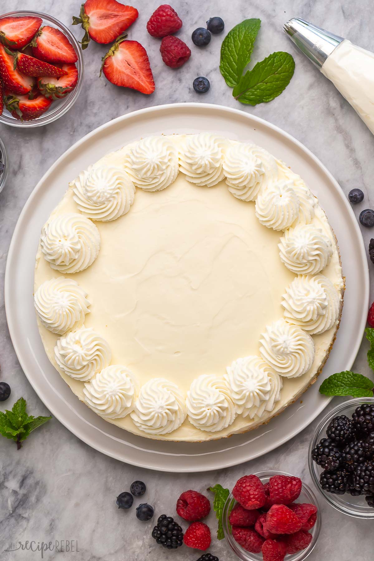 This easy Cheesecake Recipe is totally no bake and made with just SIX ingredients! Make ahead friendly no bake cheesecake for summer. #cheesecake #recipe | easy dessert recipes | summer dessert | no bake dessert | cream cheese overhead image of easy cheesecake with whipped cream.