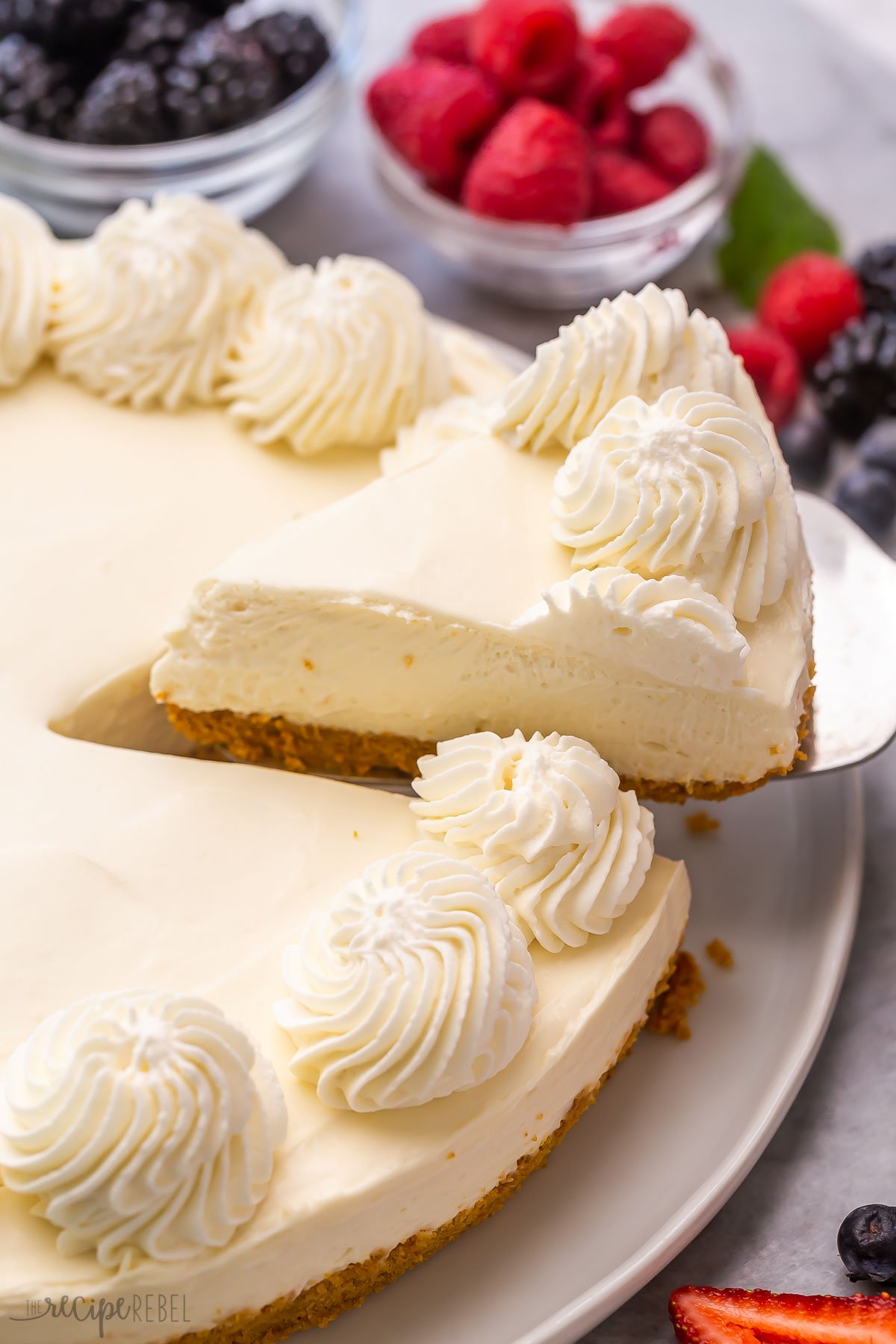 slice of no bake cheesecake being lifted out of the whole.