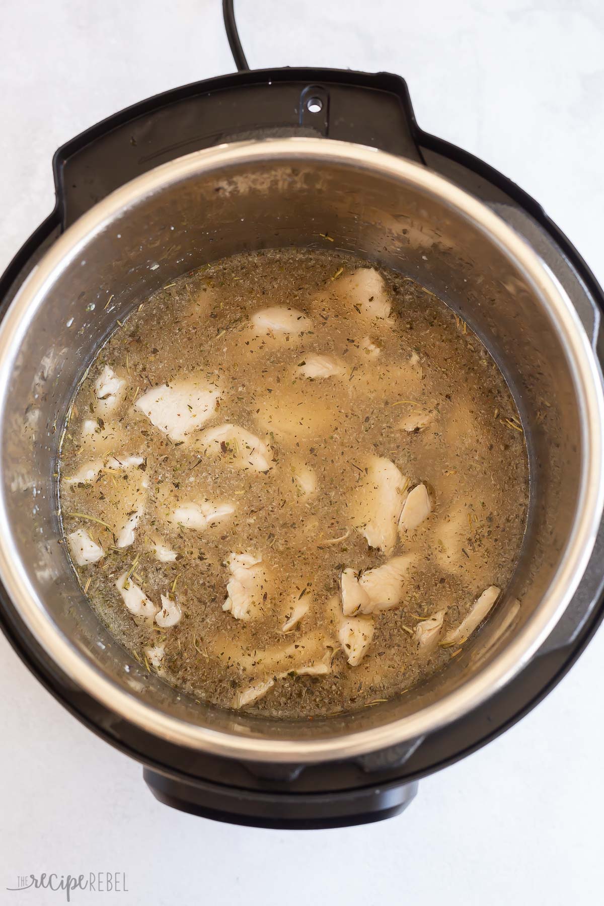 chicken broth added to chicken in pressure cooker.