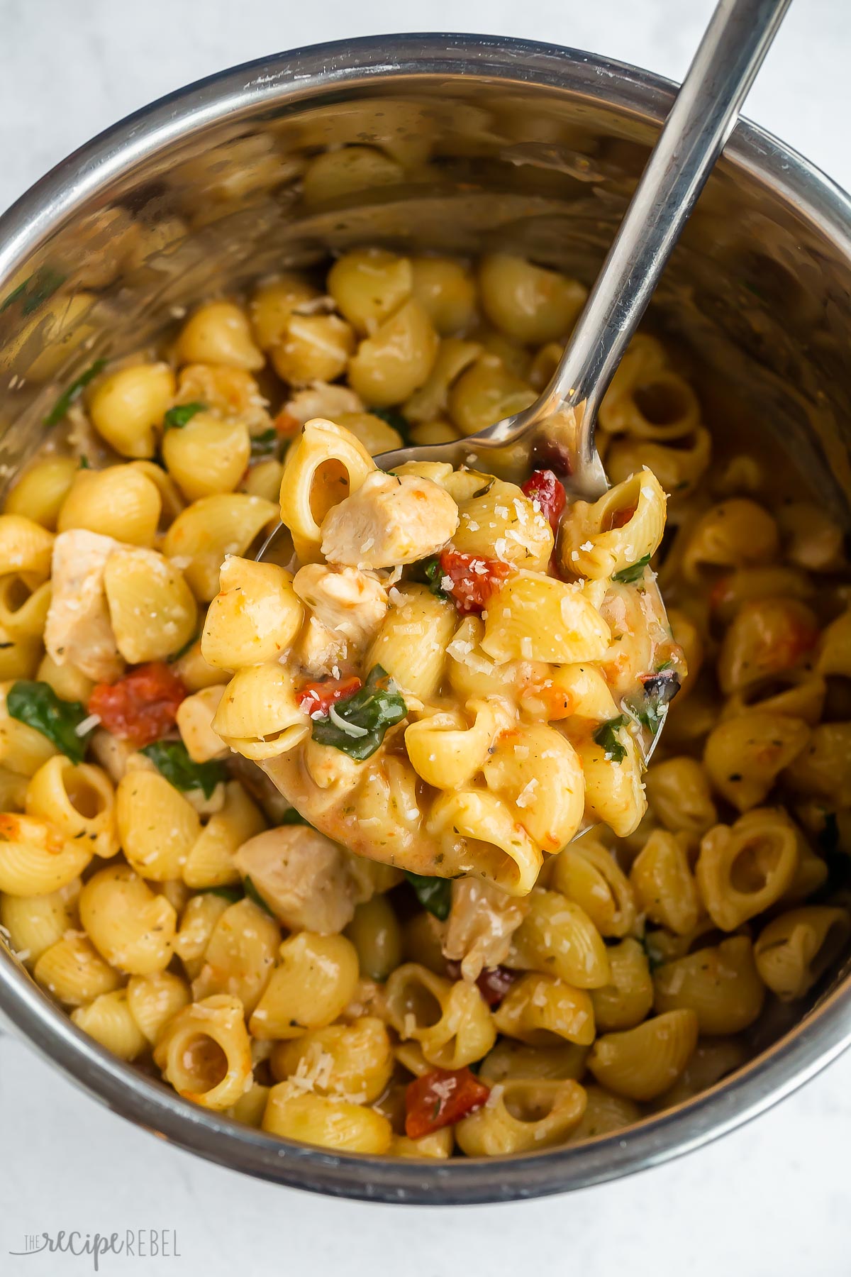 metal ladle scooping pasta from instant pot.