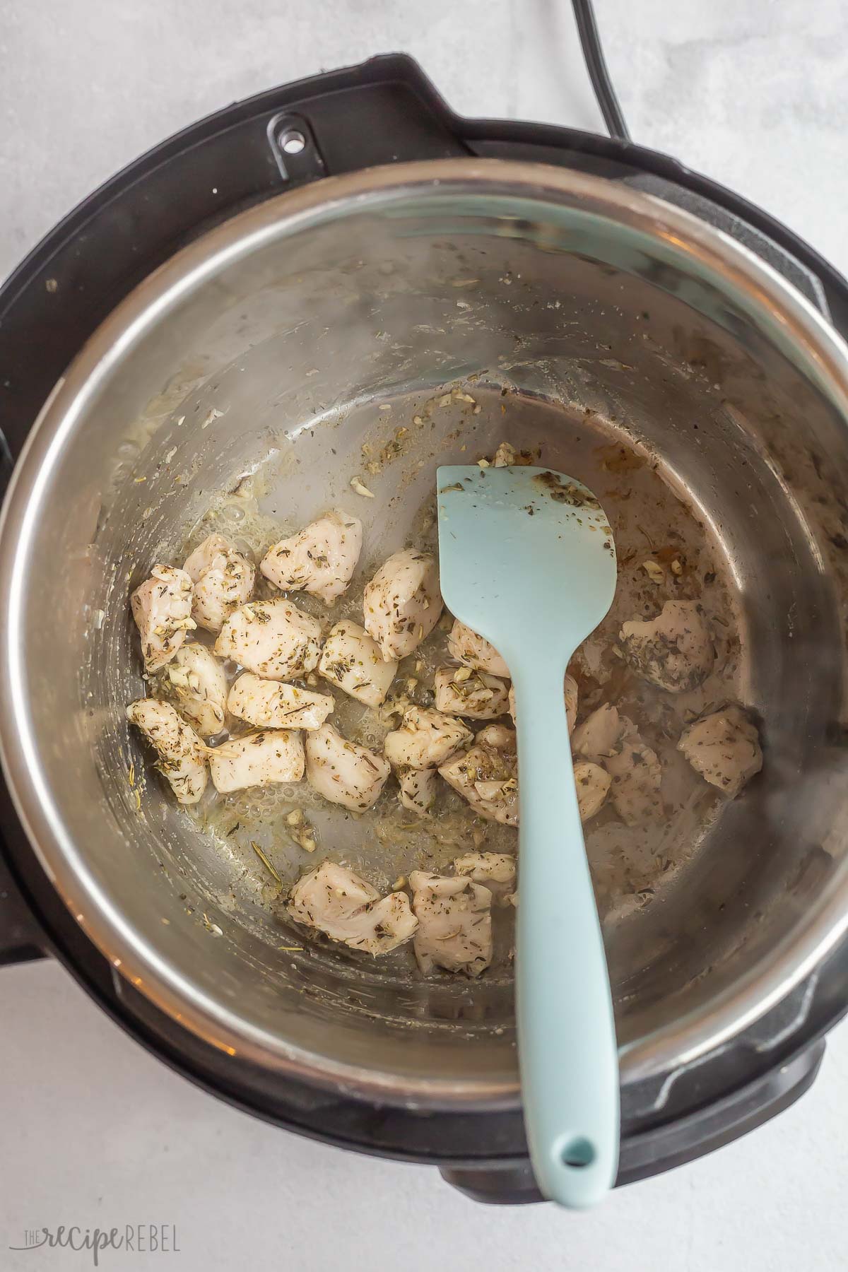 chicken cooking in instant pot with spices.