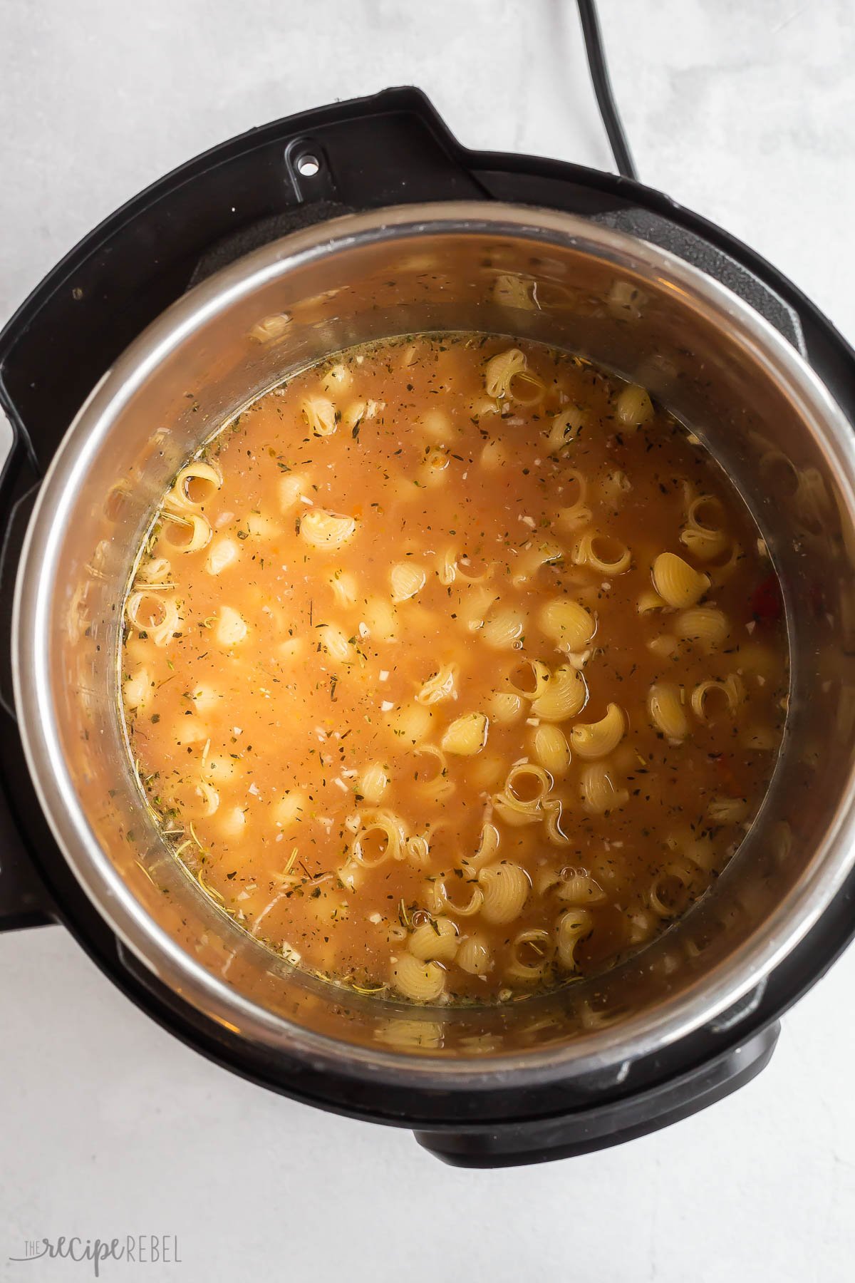 pasta added to broth and chicken in pressure cooker.