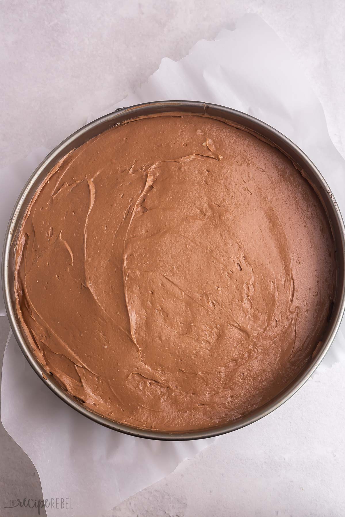 chocolate cheesecake spread into springform pan.