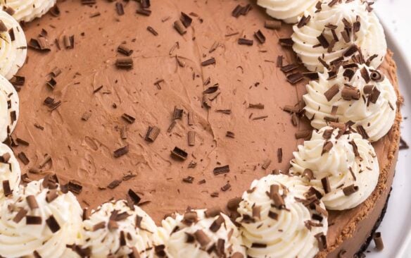 no bake chocolate cheesecake with whipped cream and chocolate shavings.