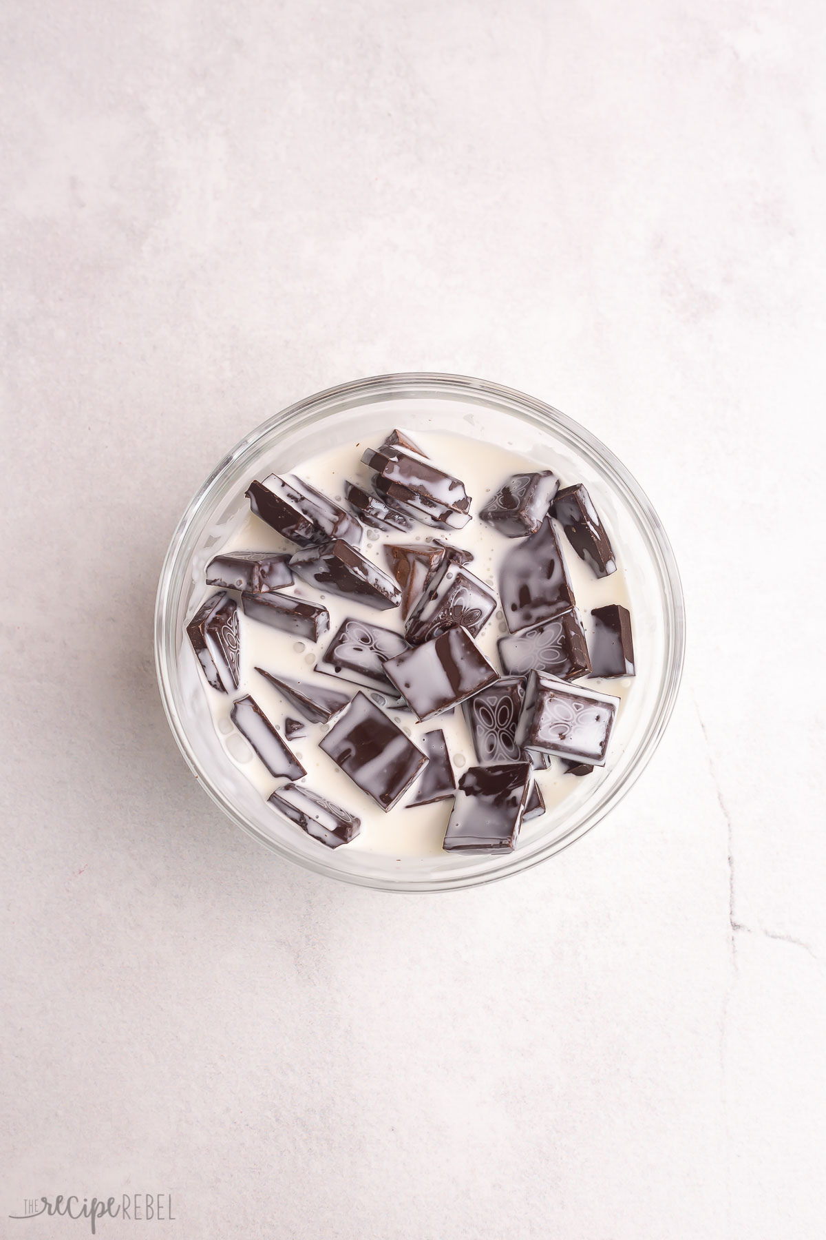 dark chocolate and cream in a bowl ready to melt.