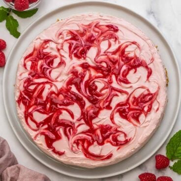 overhead image of no bake raspberry cheesecake with raspberry swirls.