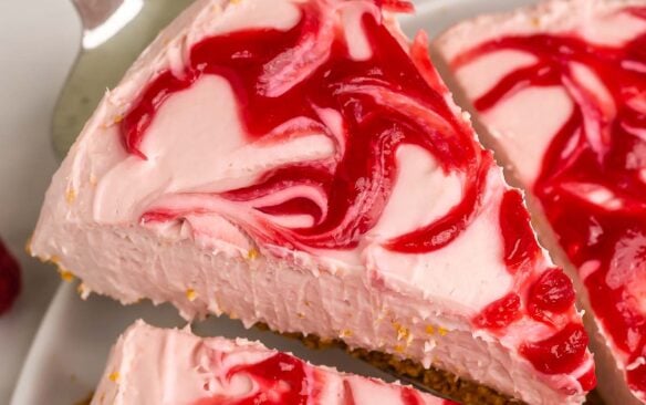 slice of cheesecake being lifted out of whole.