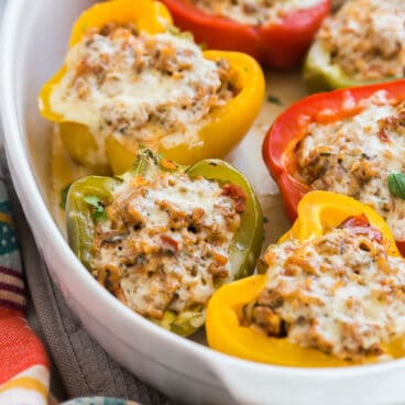 turkey stuffed peppers in white baking dish