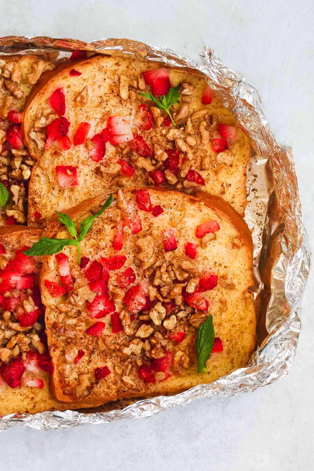 foil packet french toast overhead with chopped berries and nuts