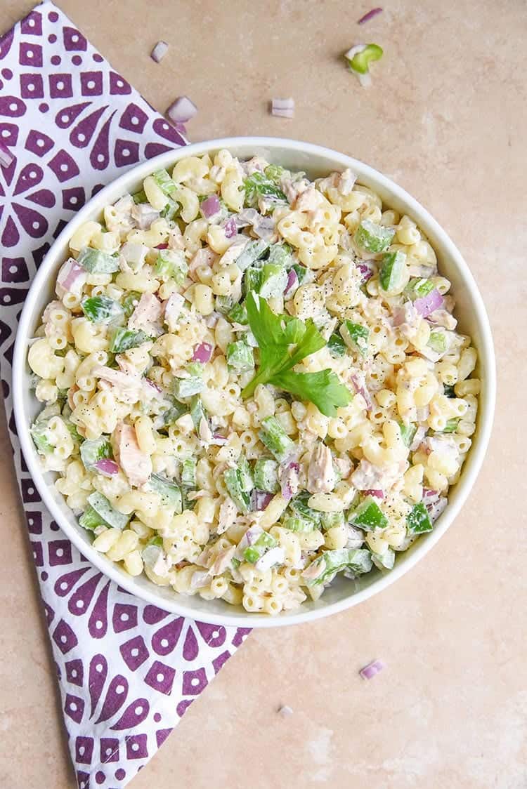 tuna macaroni salad overhead in white bowl with purple napkin on the side