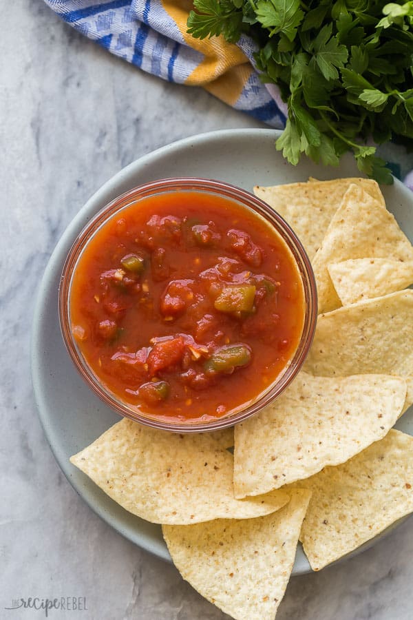 salsa recipe overhead on plate with tortilla chips on grey marble background