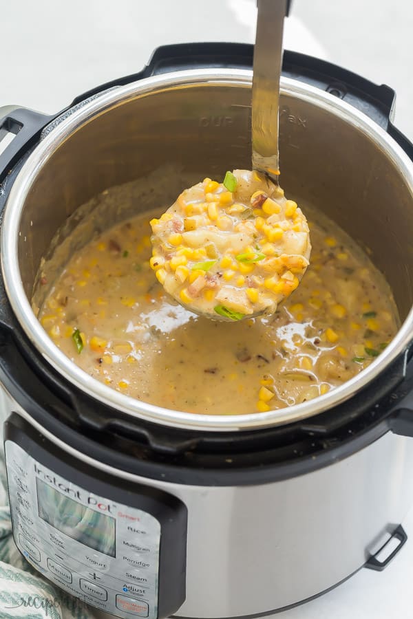 instant pot soup corn chowder with metal scoop being pulled out of pressure cooker