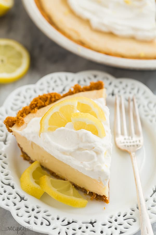 lemon icebox pie slice on white plate with scalloped edges and fork