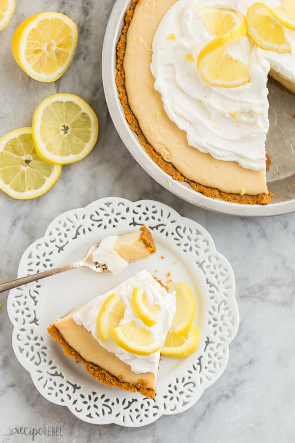 lemon icebox pie slice overhead on white plate with bite on fork