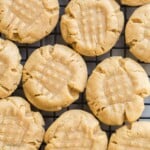 square overhead image of peanut butter cookies on cooling rack.