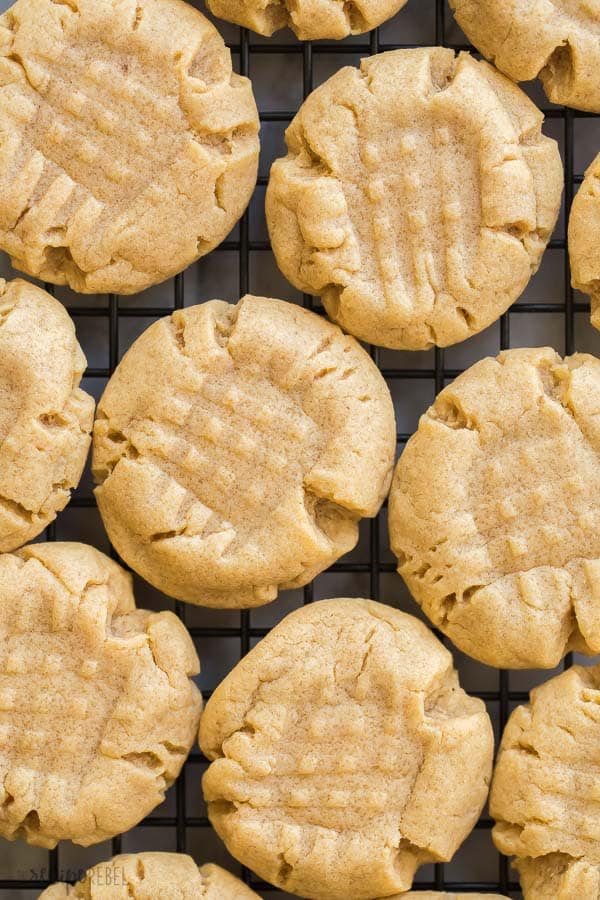 These easy Peanut Butter Cookies come together in just one bowl with simple ingredients! They're soft and chewy and freezer friendly! #cookies #cookie #recipe #dessert #recipes peanut butter cookies close up on black baking rack overhead