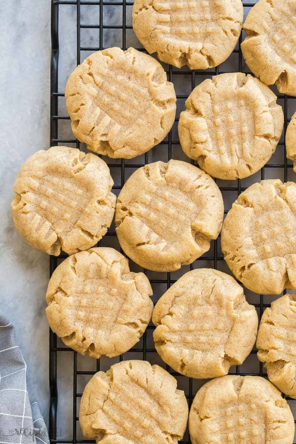 peanut butter cookies on wire rack on marble background with grey towel