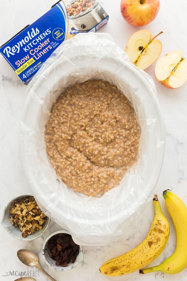 slow cooker oatmeal in white crockpot overhead with reynolds slow cooker liners box