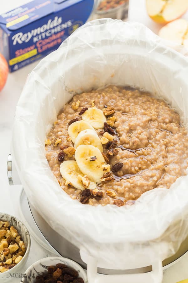 crockpot oatmeal in slow cooker with banana slices raisins and walnuts in slow cooker liner