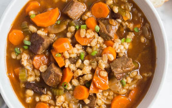 beef and barley soup in a bowl overhead