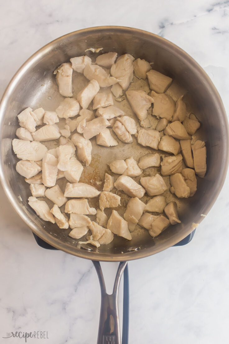 cubed chicken breast cooking in pan