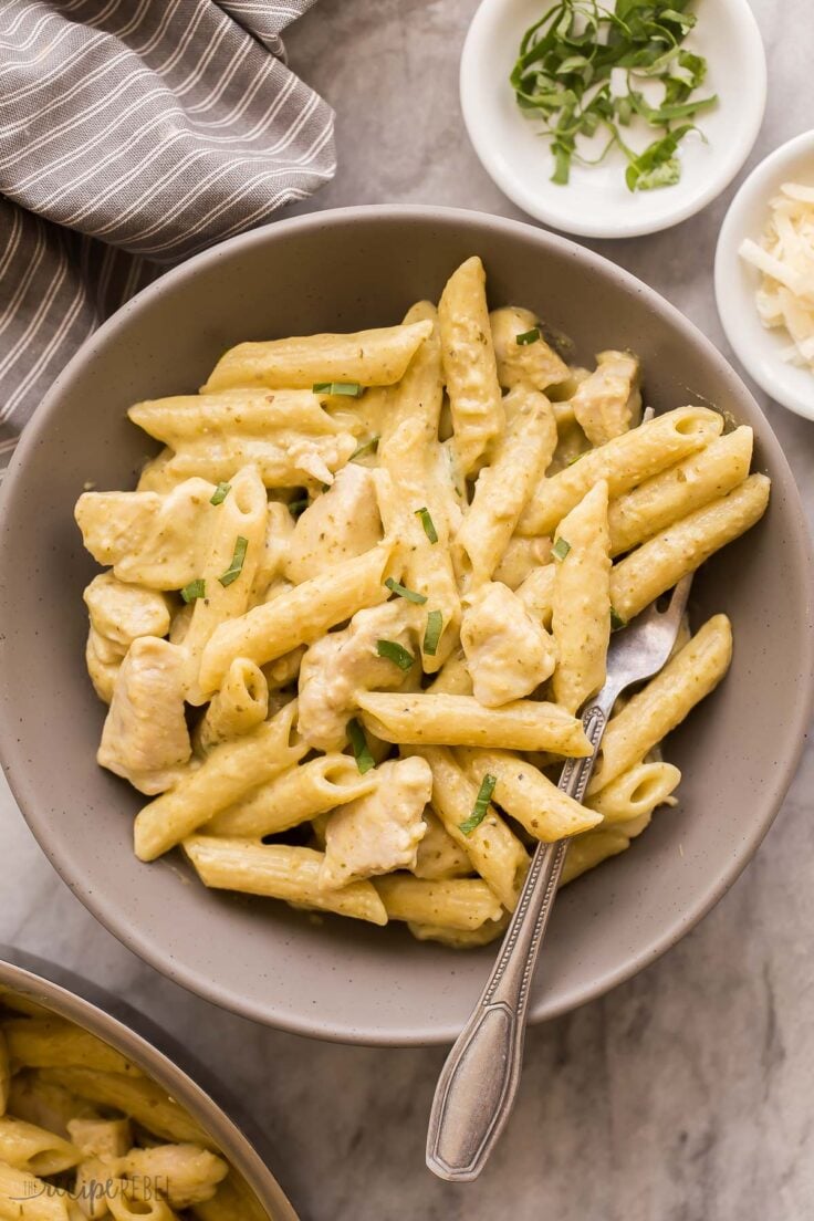 chicken pesto pasta in grey bowl with fork stuck in
