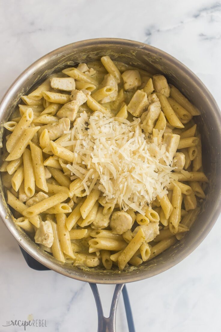 parmesan cheese added to chicken pesto pasta