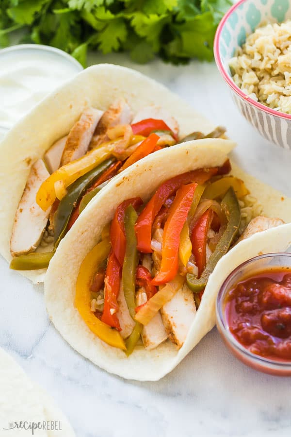 slow cooker chicken fajitas in tortilla shell close up on marble background