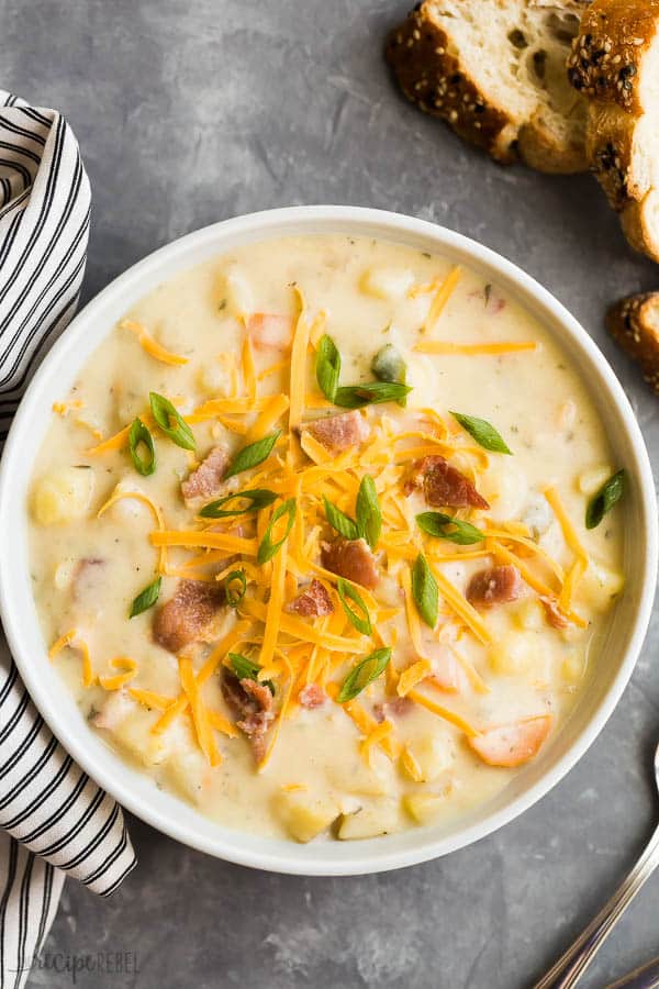 crockpot potato soup overhead in white bowl on dark grey background
