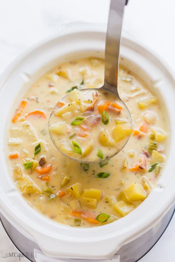crockpot potato soup in slow cooker with scoop being pulled out