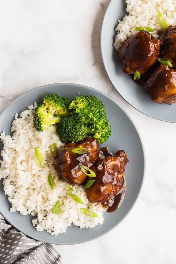 honey balsamic crockpot chicken thighs with rice and broccoli and grey plates