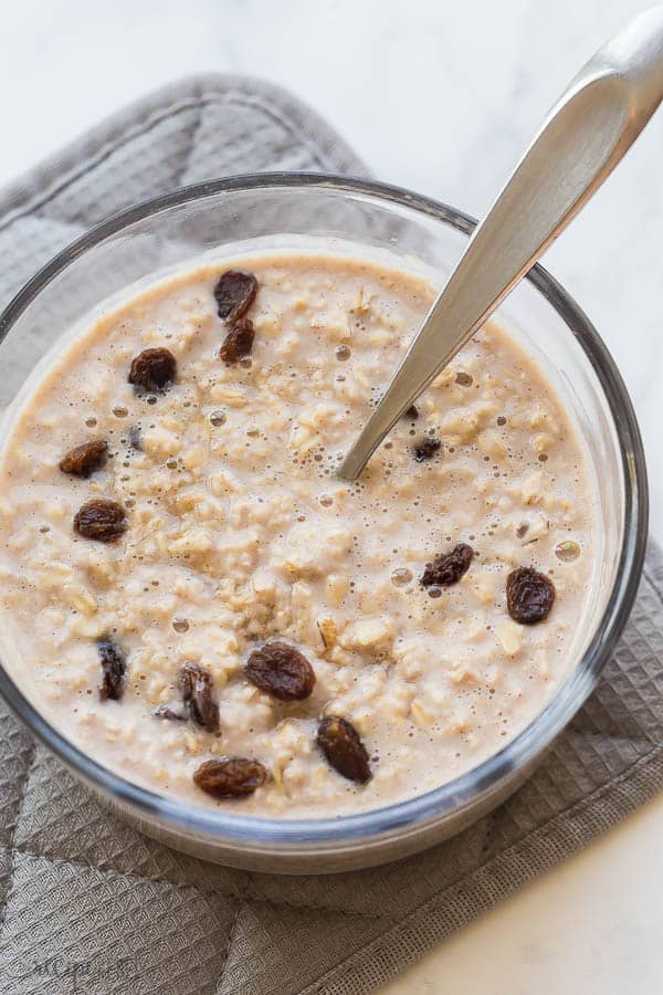 instant pot oatmeal rolled oats in glass dish with raisins on top