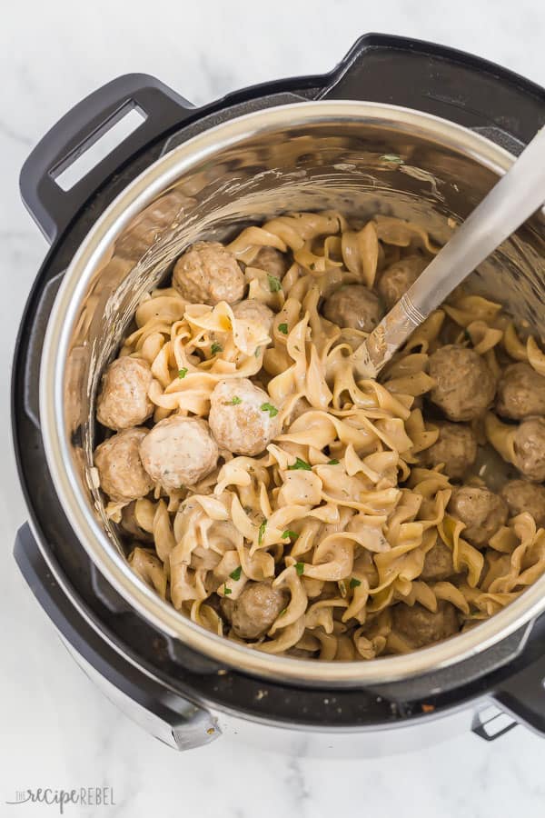 instant pot swedish meatballs in pressure cooker with metal spoon in pot